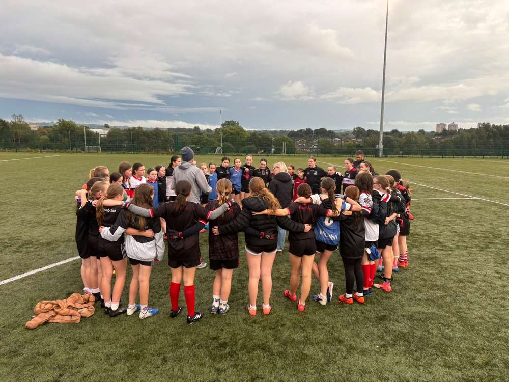St Agnes and Éire Óg U10 and U12 girls gathered after their Antrim training session
